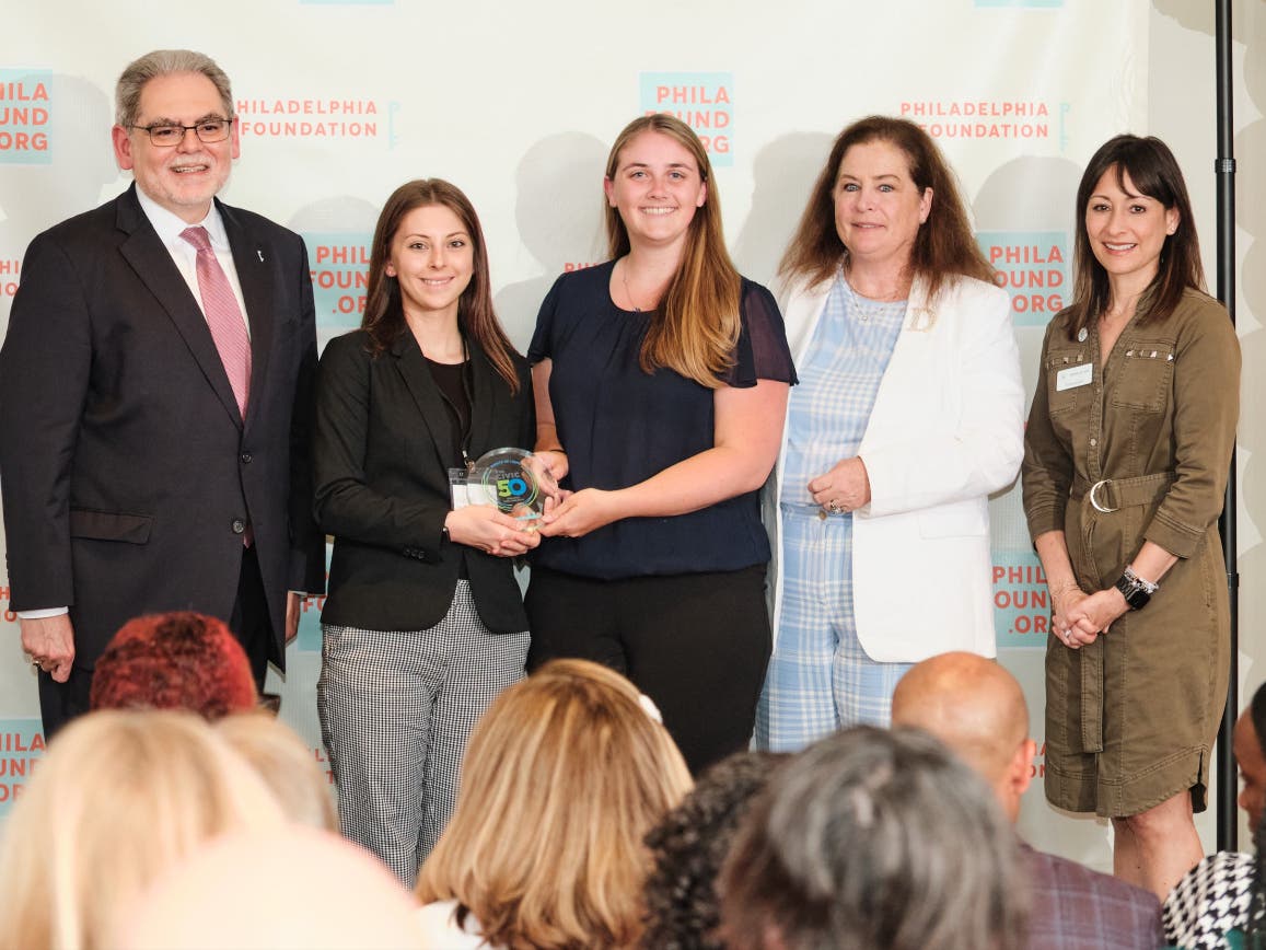 The staff at Exact Solar accepts the "Civic 50" award during a ceremony in Philadelphia.