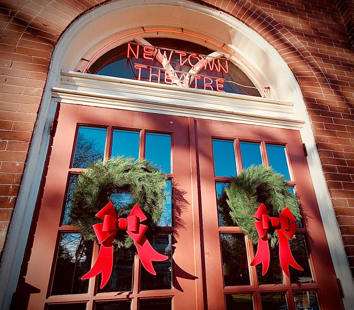 Wreaths decorate the front doors at the historic Newtown Theatre.