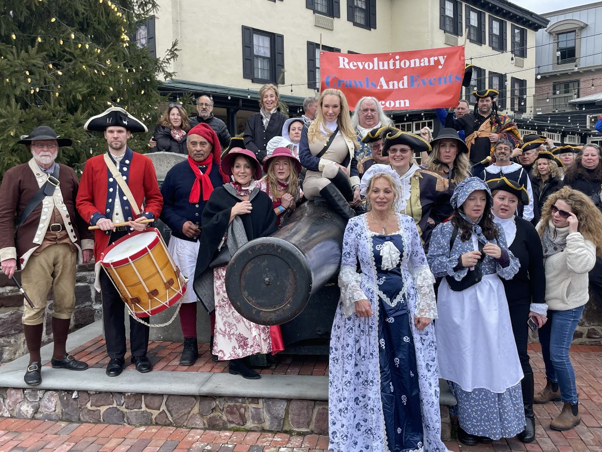 The crawlers pose for a photo in front of the Logan Inn, New Hope.