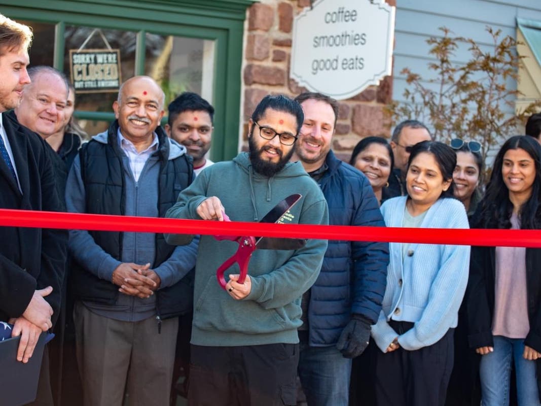 Owner Dhruv Patel cuts the ribbon on his newly-branded cafe.