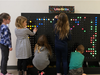 Second grade students creating designs on the new LiteBrite installation.. 