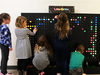 Second grade students creating designs on the new LiteBrite installation.. 