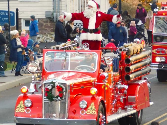 Santa arrives in Newtown aboard an antique fire truck.