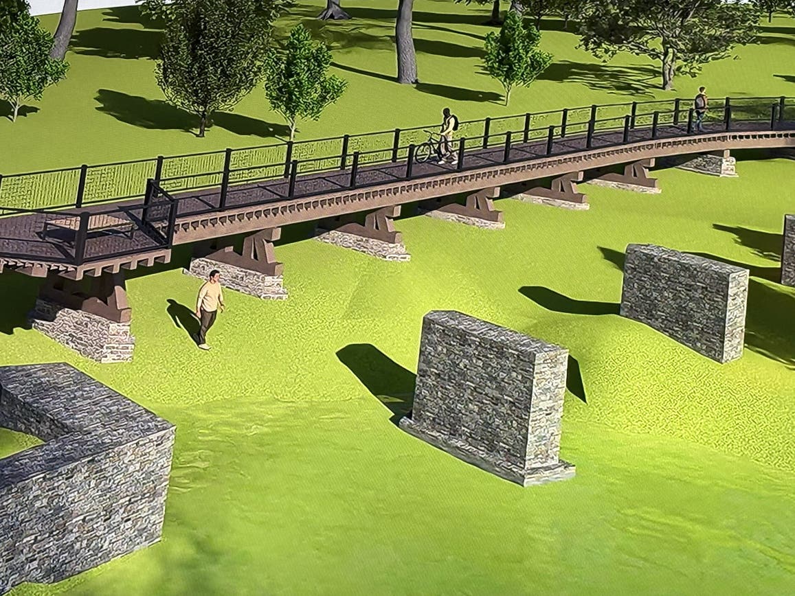 A depiction of the proposed pedestrian bridge showing the remnants of the old trolley bridge in the foreground.