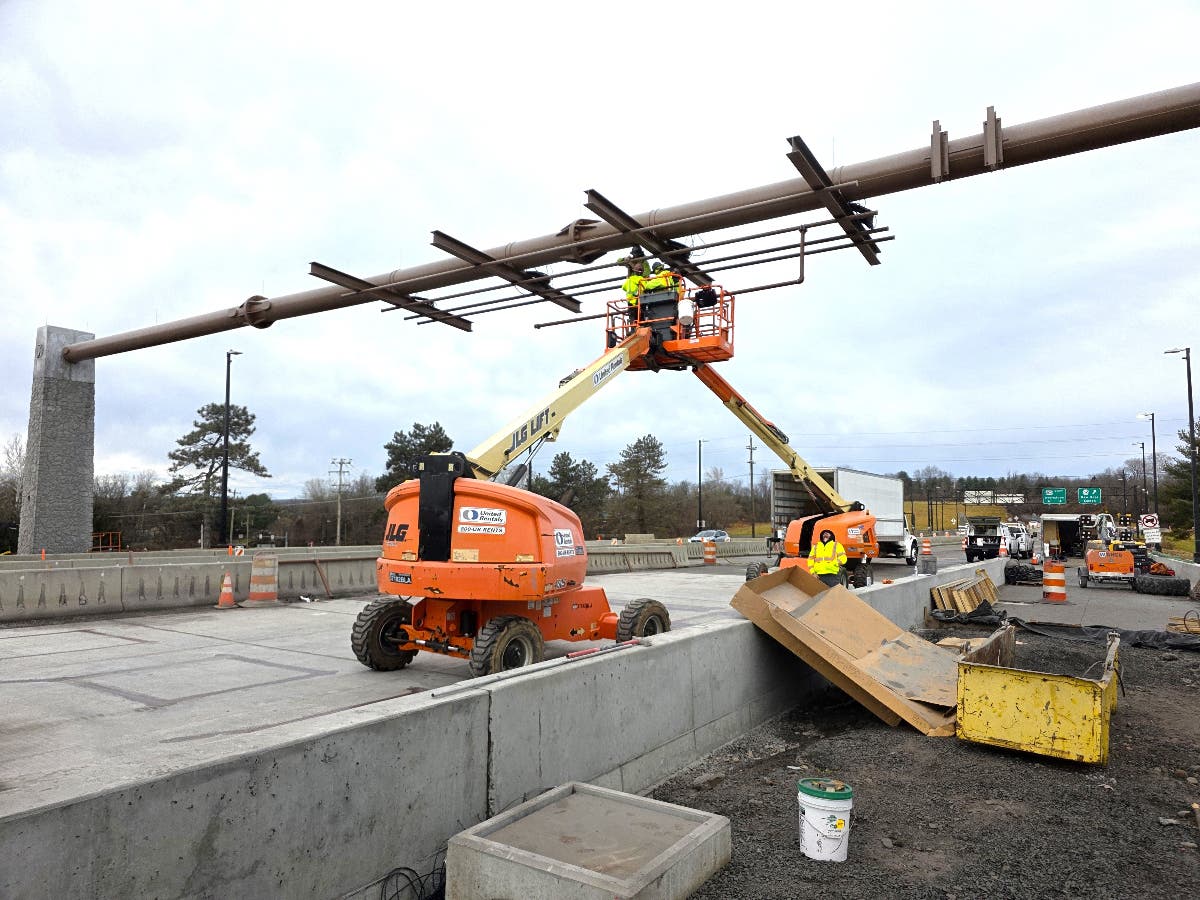 Crews work to install the new gantry above Route 202.