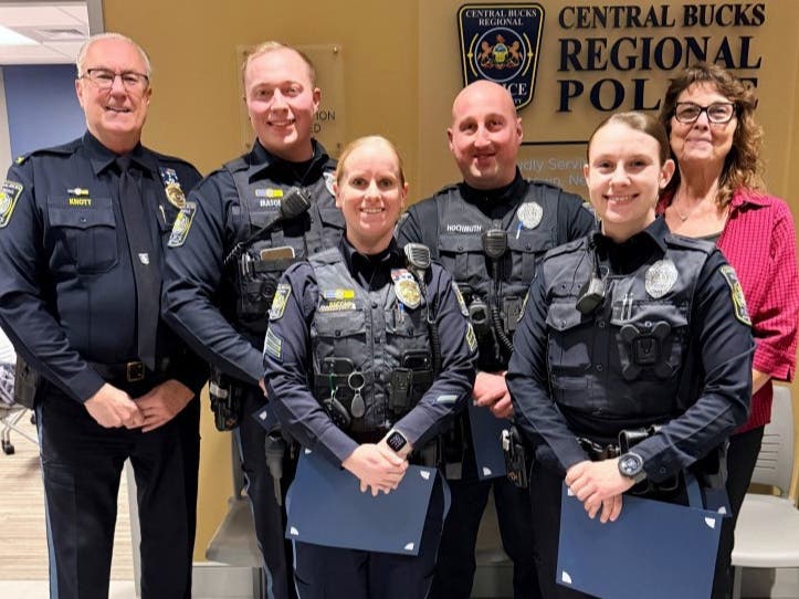 Chief Karl Knott, left, presents the Distinguished Unit Citation to Sergeant Jaclyn Riccio, Officer Andrew Hochmuth, Officer Zack Mason, Officer Alicia Belli, and Victim Specialist Karen Edwards.
