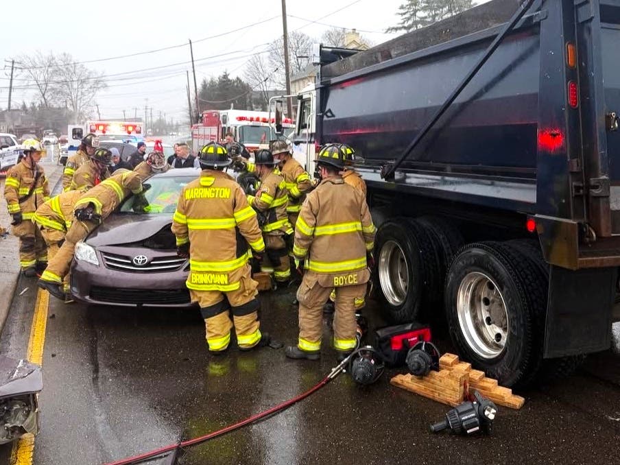 Firefighters work to extricate the driver of a car in a crash at Route 611 and Bristol Road.