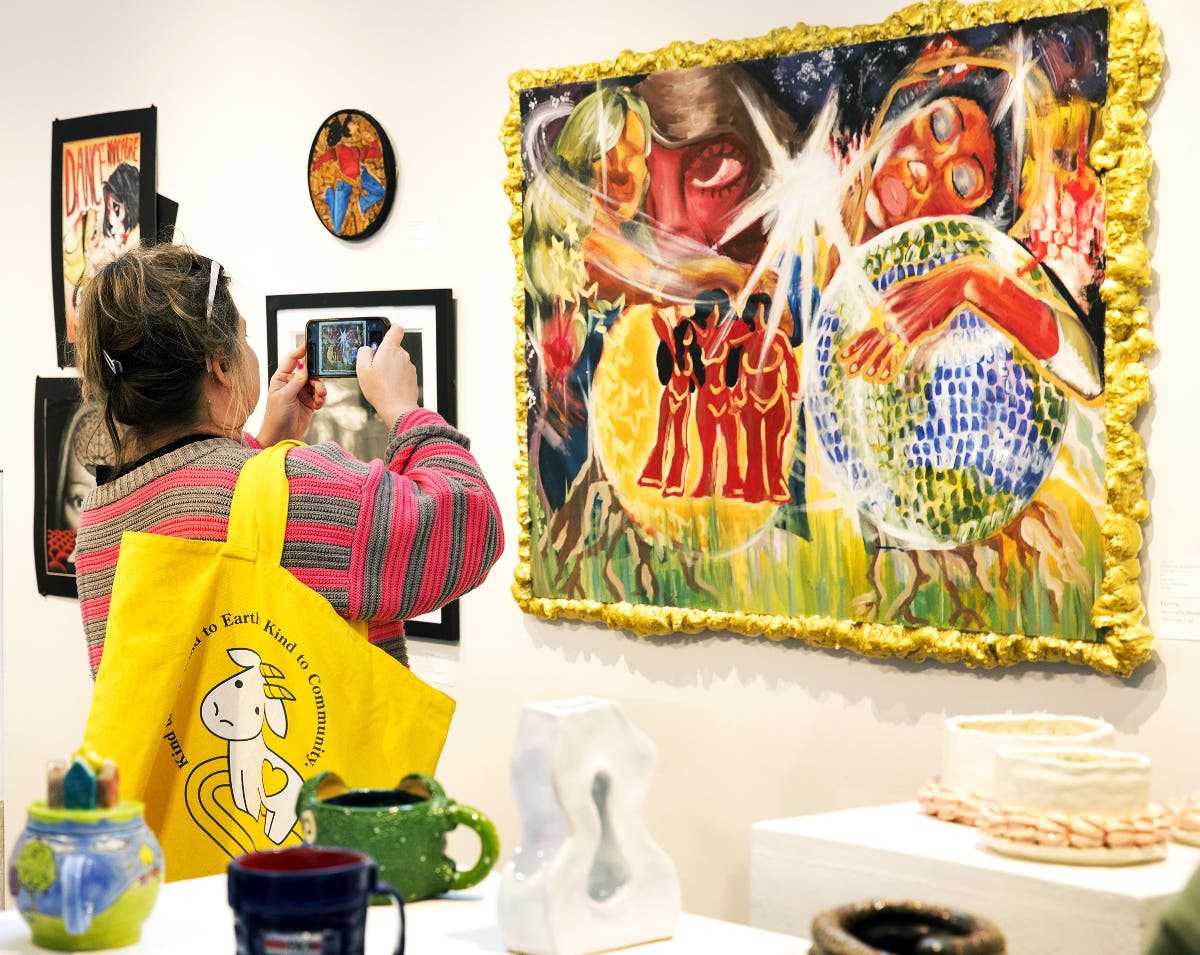 A visitor snaps a picture of a painting at last year’s High School Art Exhibition in the
Hicks Art Center Gallery at Bucks County Community College. The 31 st annual show
and Congressional Art Competition take place March 18 to April 5.
