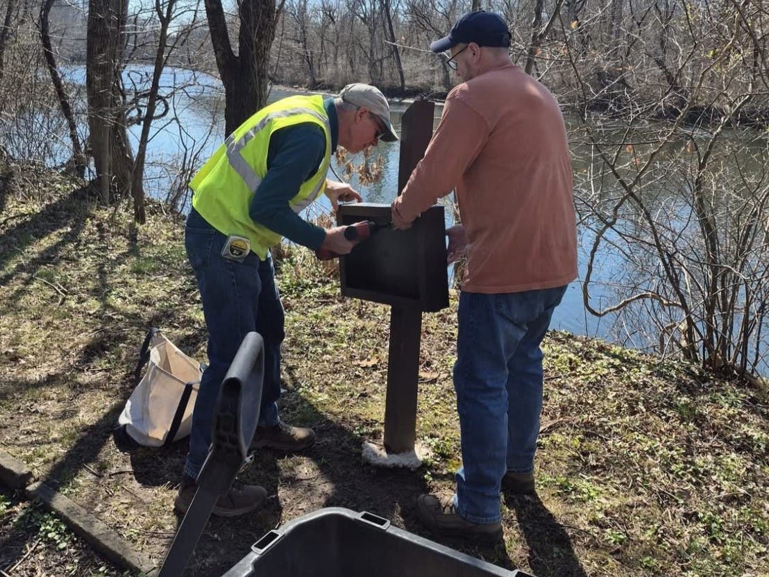 Volunteers with the Friends of Tyler State Park reinstall the vandalized story stroll.