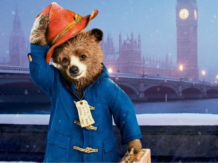 Paddington Bear tips his hat.