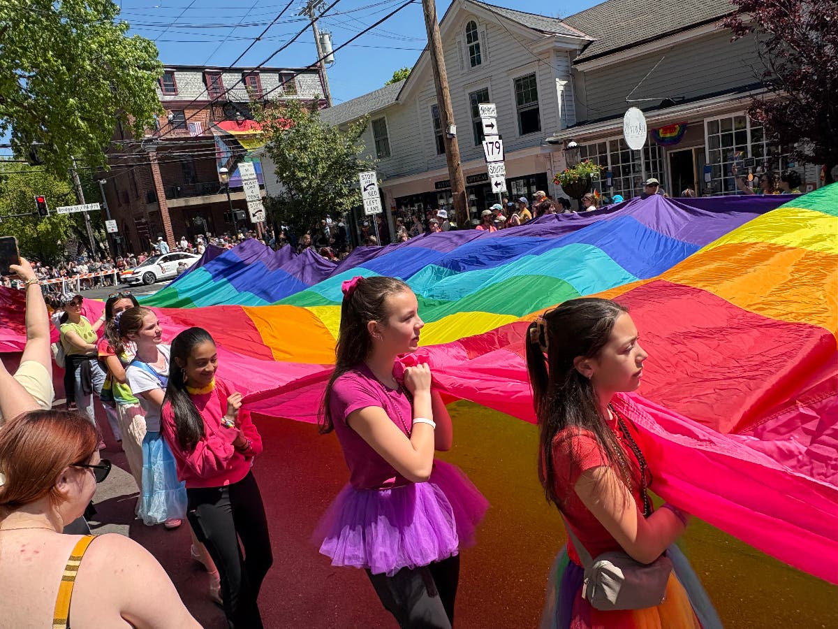Carrying the Rainbow Equity flag down Main Street in New Hope.