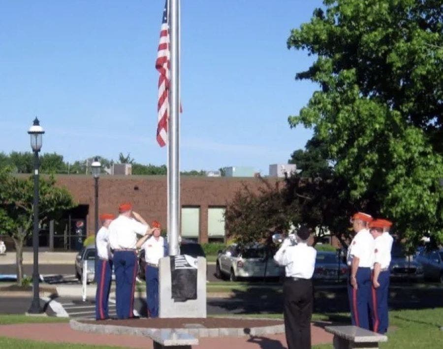 Raising the flag in front of the township building.