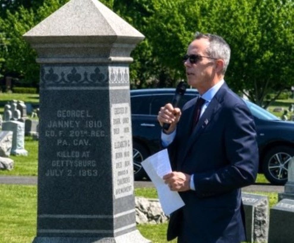 State Senator Steve Santarsiero reads a letter from the granddaughter of General George S. Patton during a ceremony remembering John Janney in Newtown.