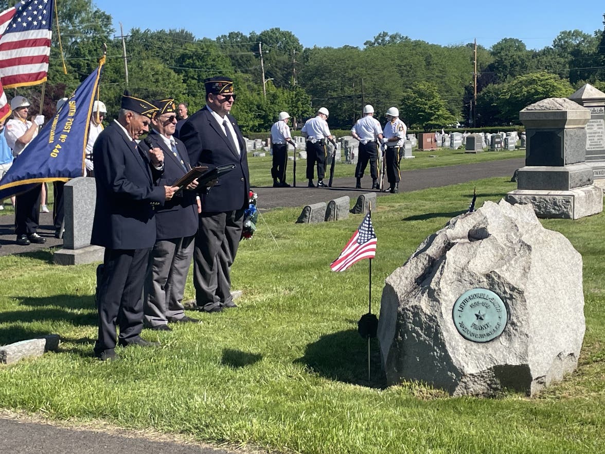 Veterans render honors at the grave of Morell Smith at the Newtown Cemetery.