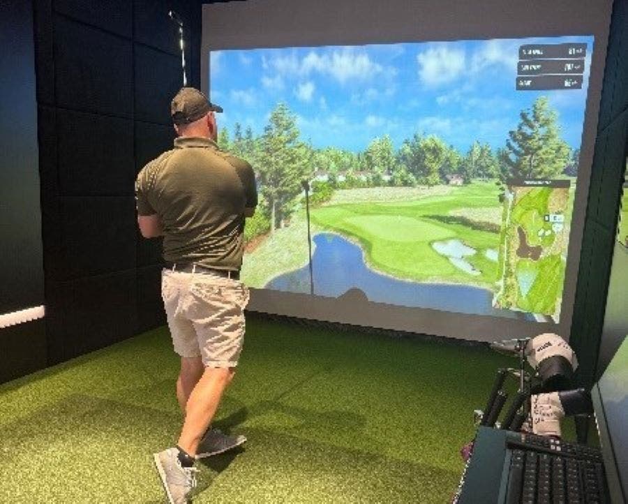 A golfer tests out the new golf simulator at Warrington's Fairways Golf Club.