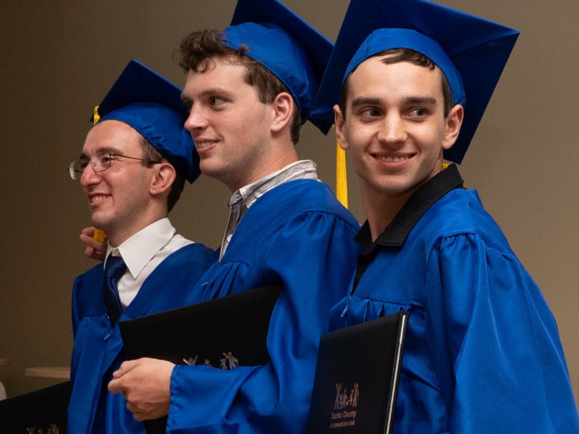 Bucks IU graduates from the Pennridge School District, from left, Carmine Galante, Thomas (TJ) Deacon, and Kaden Wynne pose for photos at the June graduation ceremony.