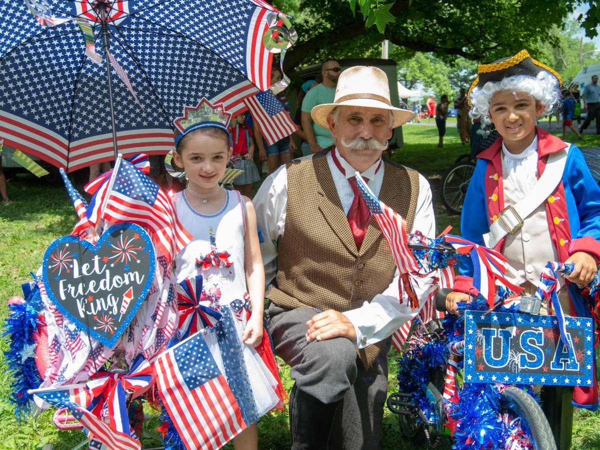 "Henry Mercer" and two young visitors celebrate during last year's Fourth of July celebration.