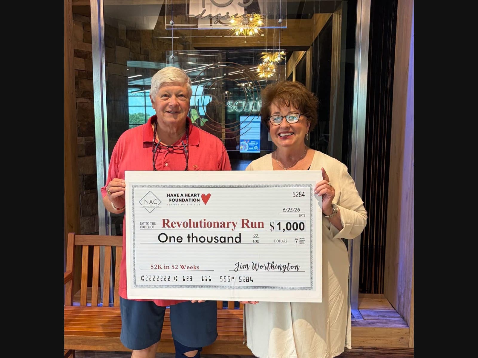 Harry Barfoot, President, Upper Makefield Business Association, accepts a donation from Linda Mitchell, director, NAC Have a Heart Foundation, in support of the Revolutionary Run.