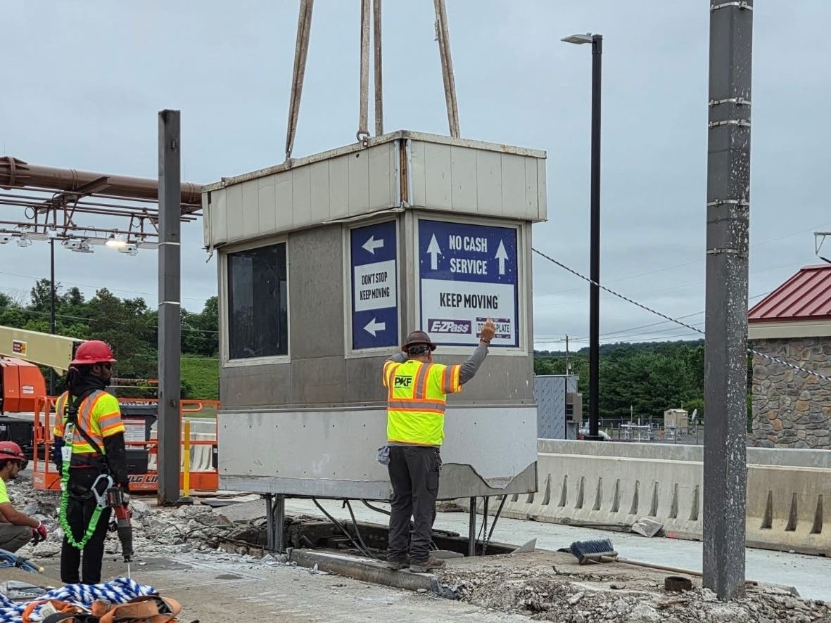 Workers remove the last toll booth at the Route 202 toll bridge.