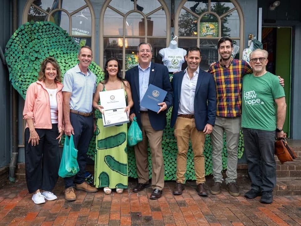 Pickle store owner Abby Truitt is joined by community leaders in celebrating the opening of Giovanni's Dillicious Pickles in New Hope.
