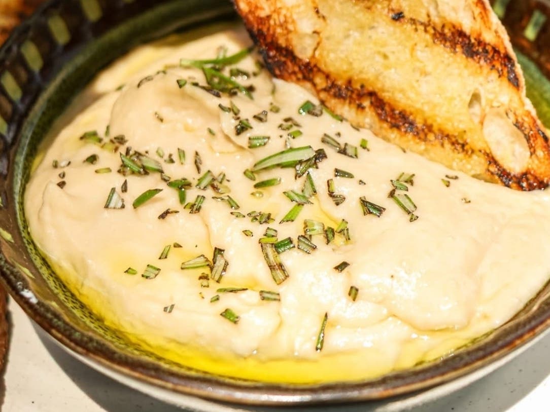 Ardana Food and Drink in Warrington and Newtown will be donating proceeds from the sale of its Roasted Garlic & White Bean Dip to the cause. The dip is drizzled with rosemary oil and served with grilled bread.
