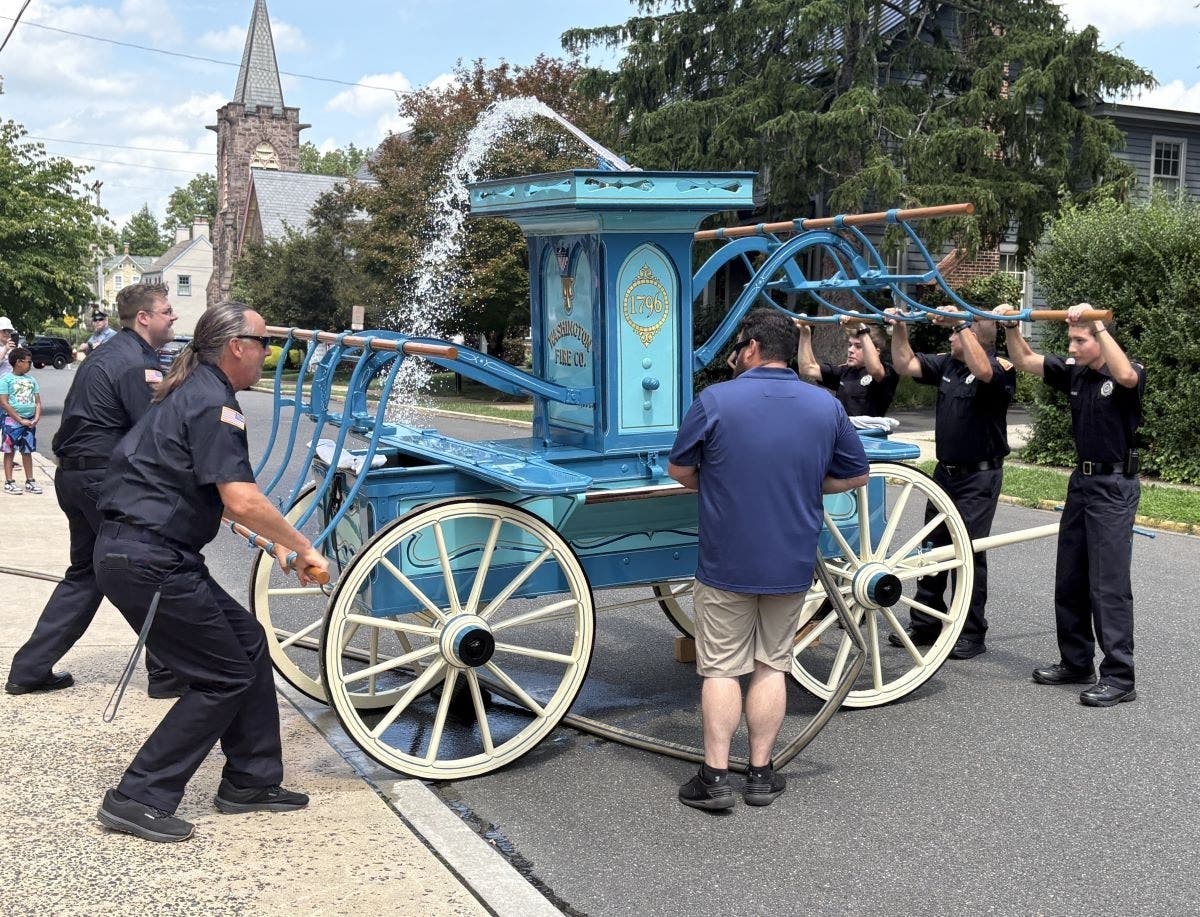 Firefighters demonstrate "Old Washy" on Liberty Street.