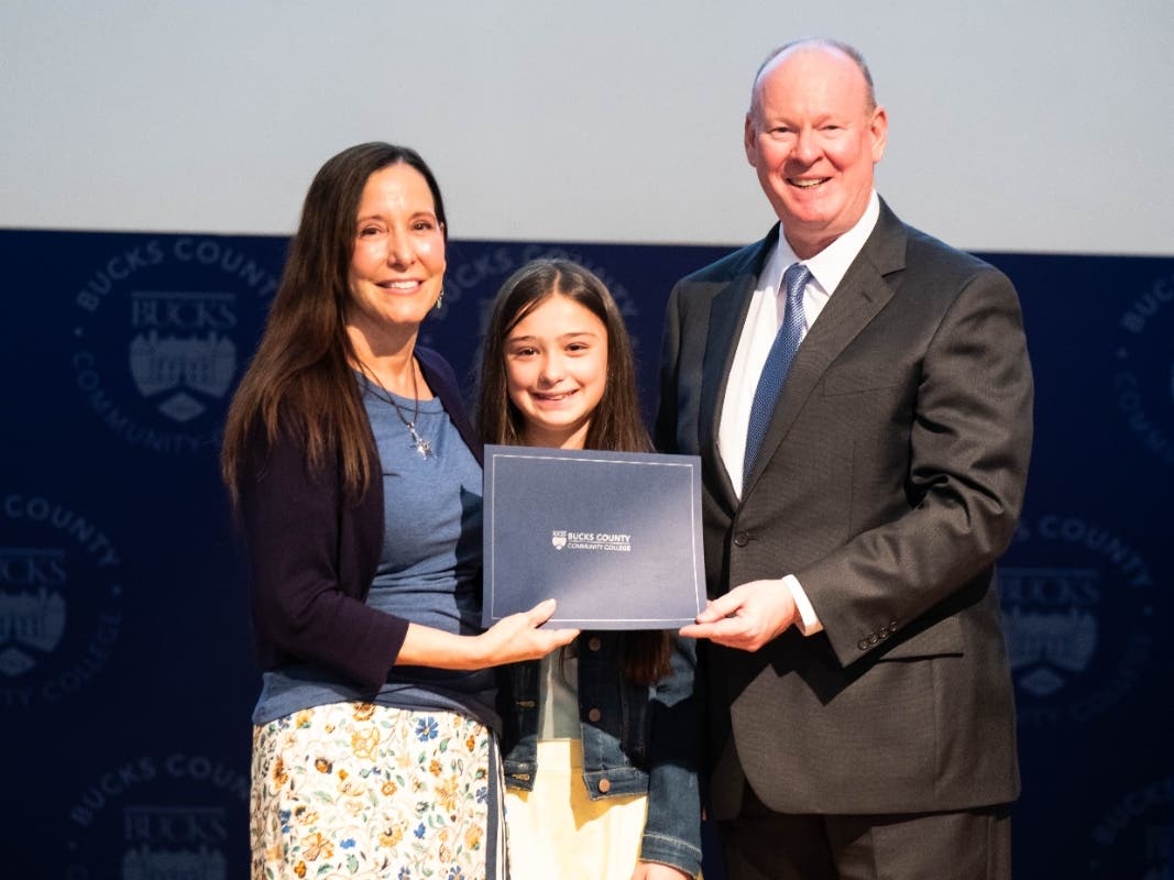 Mary Dura, Ed.D., accepts the prestigious 2026 Lindback Award for Distinguished Teaching from President and CEO Patrick M. Jones, Ph.D., while accompanied by her daughter