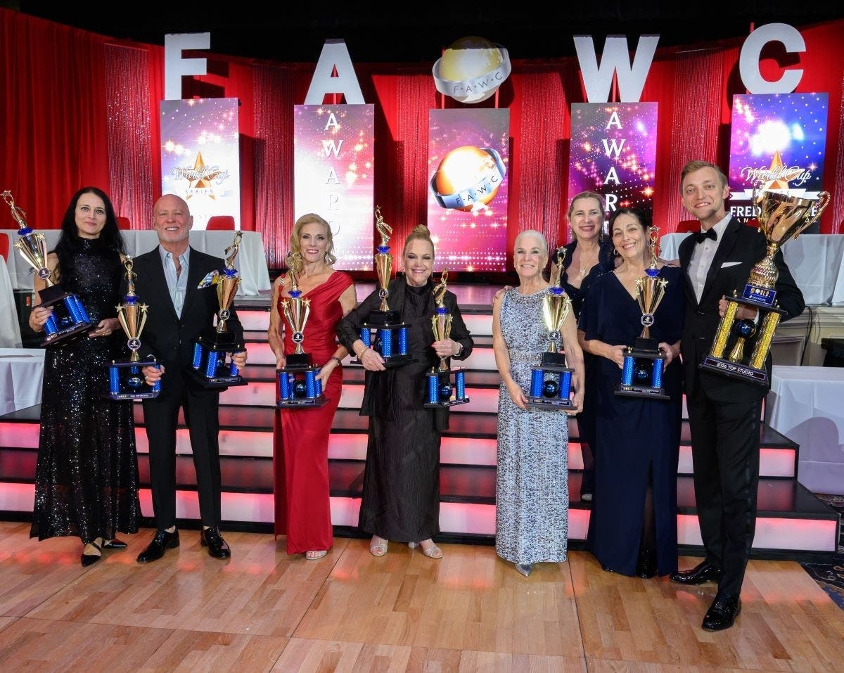 Members of the Newtown Fred Astaire Dance Studio accept the top studio award.