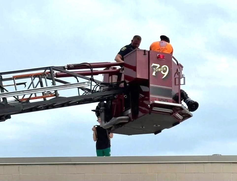 Tower 79 transports a Doylestown Township police officer to the roof of the vacant grocery store.