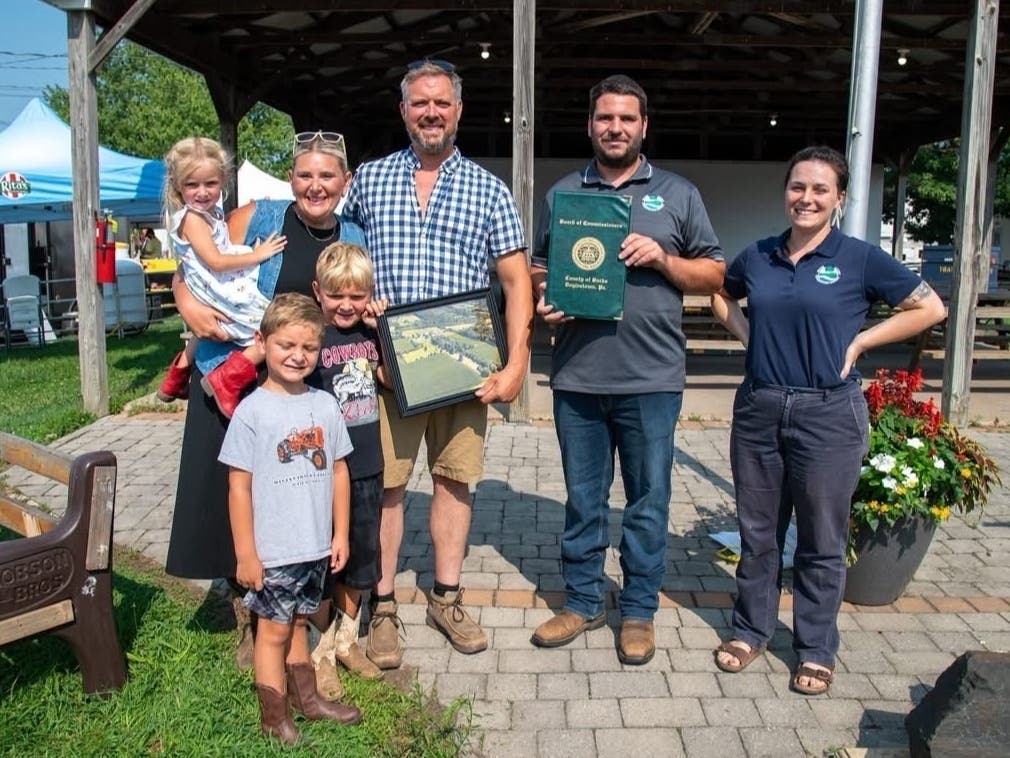 The Bishop Family is presented with the Fred Groshens Farmer of the Year Award by representatives from the Bucks County Conservation District.