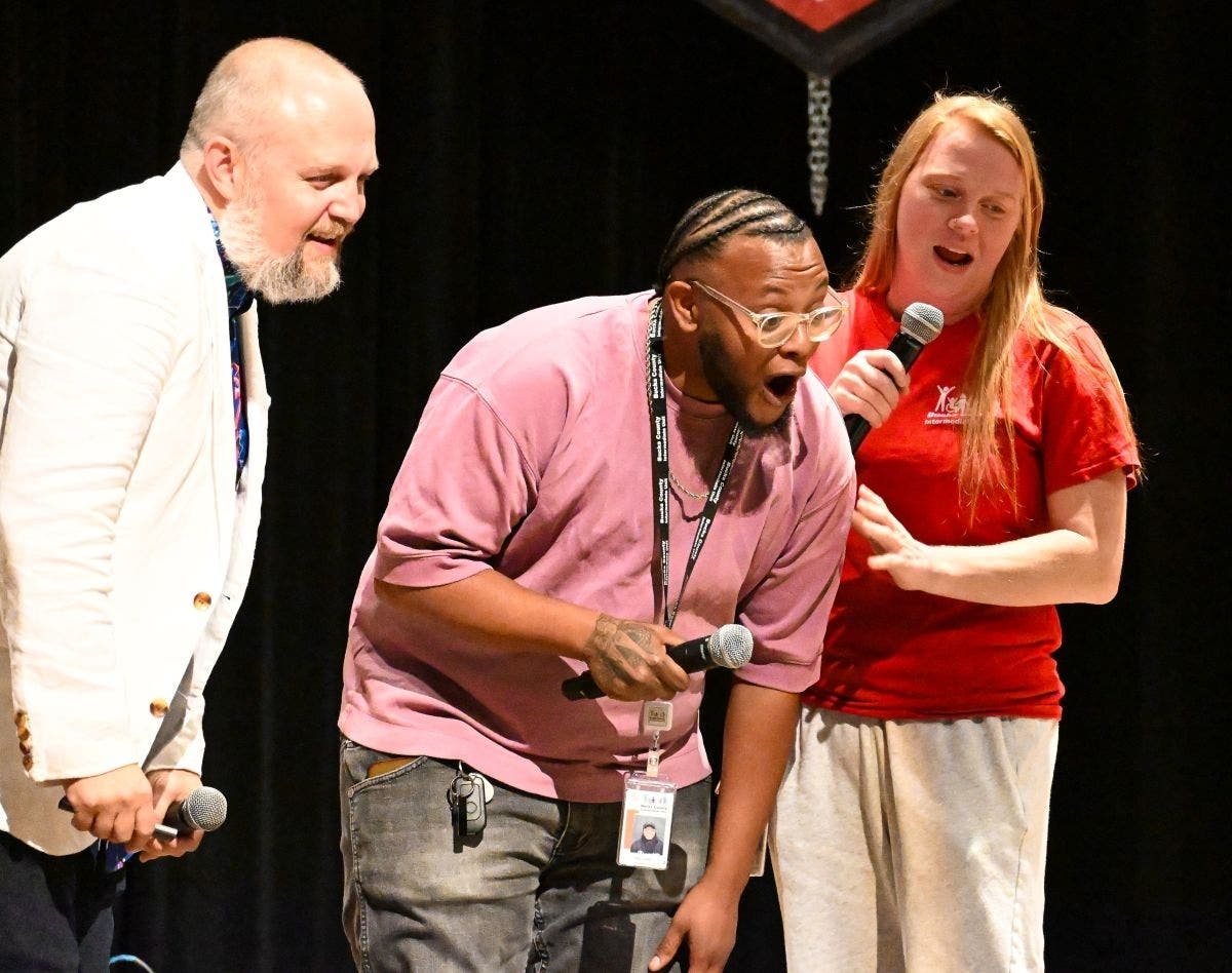 Two Bucks IU staff (right) participate in an early childhood conflict resolution skit with the Opening Day Keynote Speaker, Brian Buffington (left).