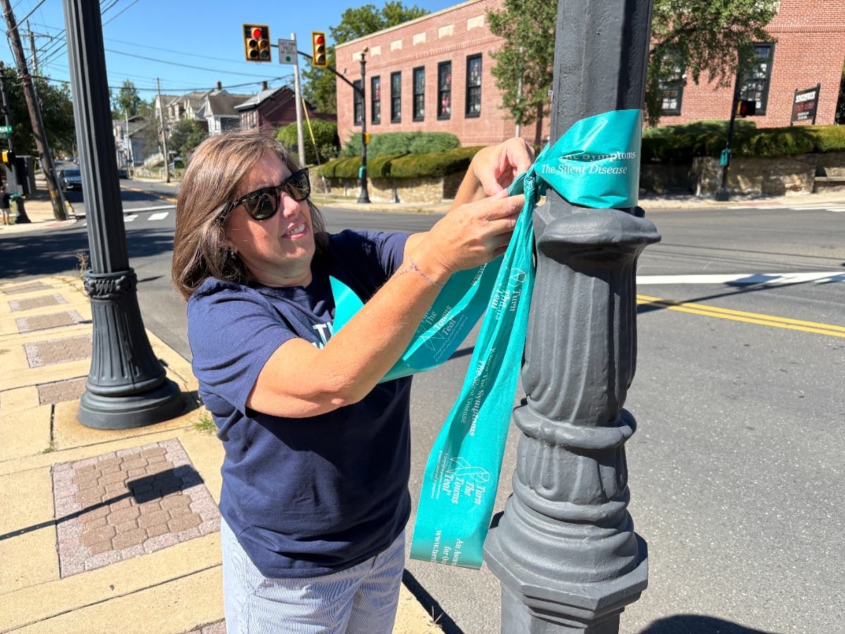 A volunteer decorates a light post with a ribbon during last year's effortt.