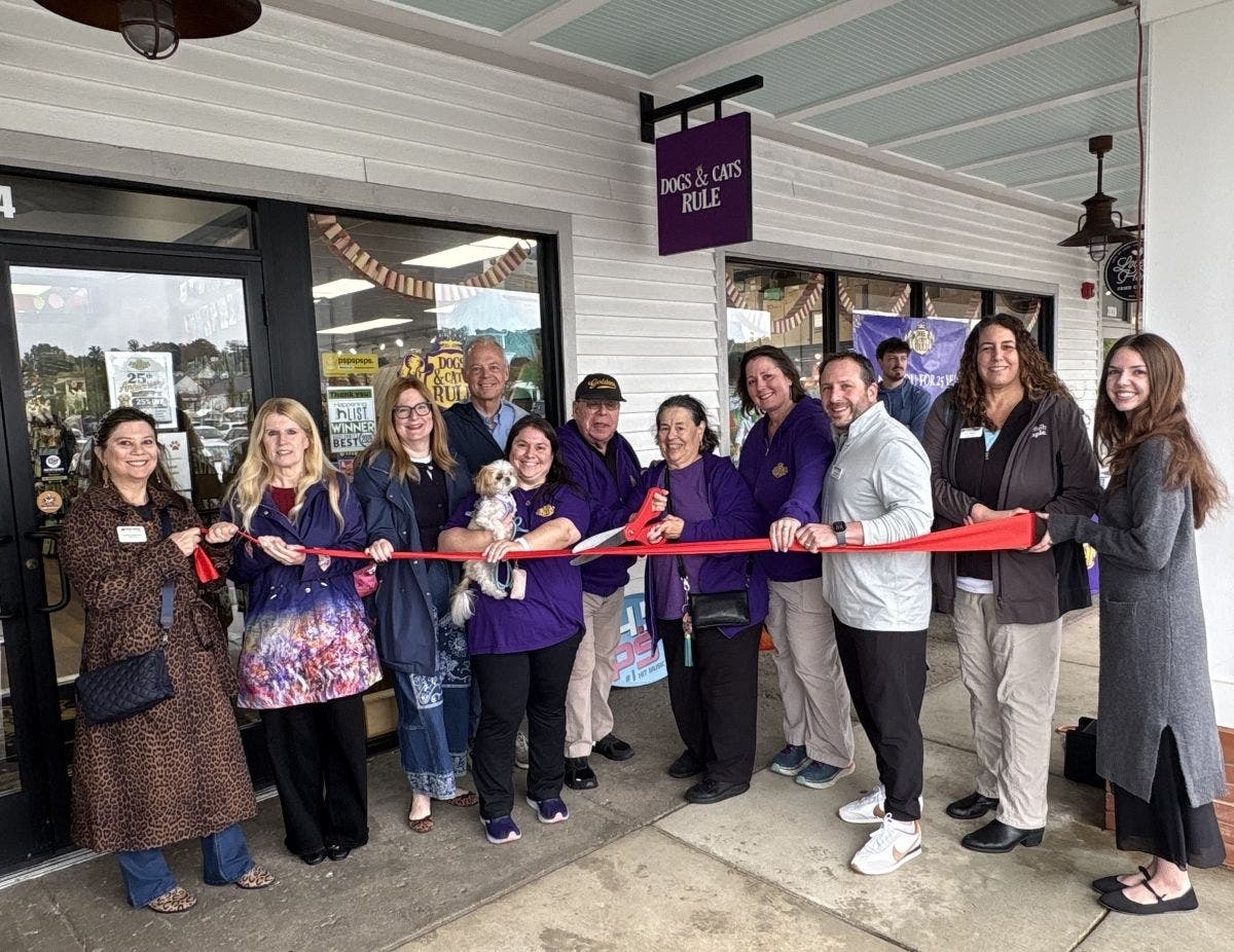 George Parente and his sister, JoAnn, join State Rep. Perry Warren and representatives from the Newtown Business Association at a ceremonial ribbon cutting at Dogs & Cats Rule in Newtown.