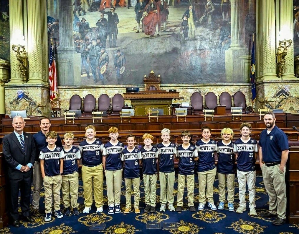 State Rep. Perry Warren, left, welcomes the team to the Pennsylvania House of Representatives in Harrisburg.