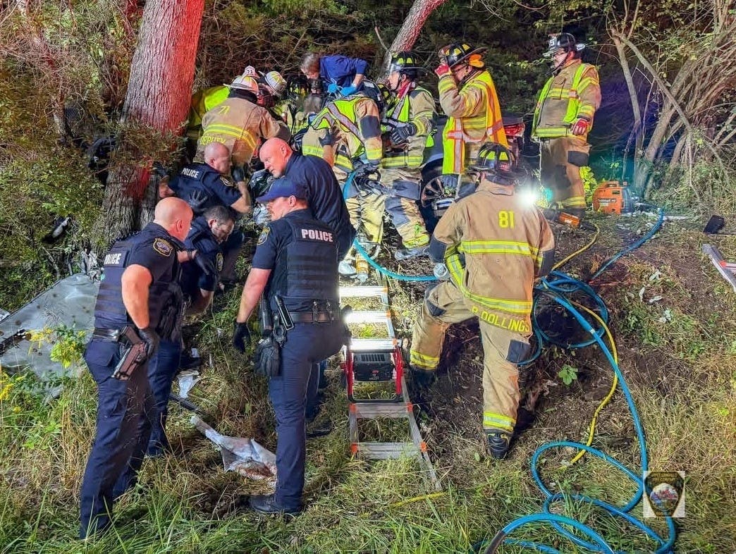 Firefighters work to free a driver trapped in a car following a one-car crash Sunday morning in Upper Makefield.