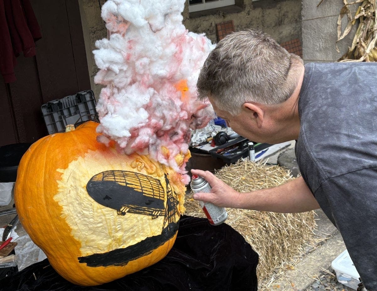 Mike Cousart of Chalfont works on his pumpkin depicting the Hindenburg airship disaster. His creation went on to win last year's grand prize. (Jeff Werner/Patch)