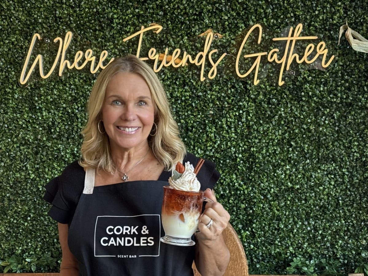 Linda Welles, owner of Bucks County's first Cork & Candles store, is holding one of the store's novelty candles.
