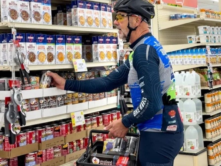 A cyclist loads up on non-perishables during "Cranksgiving."