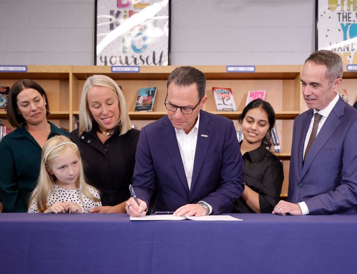 Governor Josh Shapiro signs the bell-to-bell cell phone bill into law on Monday at the Lenape Middle School in Doylestown.