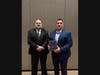 Michigan Rural Water Association President Todd Hackenberg, left, presents the 2026 MRWA Person of the Year award to Deputy Public Services Director Brad Lear. 