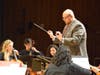 Maestro in Action: Mr. Feigenbaum, conductor of the Ossining High School Orchestra, leads his talented students with precision and enthusiasm at the White Plains Orchestra Festival.