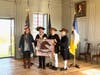 Presentation of the Guidon in the Great Hall at Stratford hall.  L-R:  Kelley Dietz, VP Collections and Public Engagement at Stratford Hall, Ken Bonner President SMJC Chapter, Barry Schwoerer VP SMJC Chapter, Mark Sink SMJC Chapter