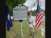 Sgt Maj John Champe Chapter President Barry Schwoerer next to the sign dedicated in honor of Robert Carter III
