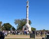 Yorktown Victory Monument with large crowd surrounding the base