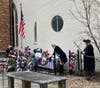Tomb of the Unknown Revolutionary war soldier.  General George Washington  (Brian Hilton) placing a rose on the tomb.  The Rev. Massey (Tom Costa) to the right