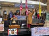 Sgt Maj John Champe Chapter float in front of the Reviewing stand;  Warner Workman in brown hunting frock, waving to the crowd