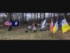 Field of Flags with Headstone of Captain Jeremiah Smith  in background.  Paul Christensen, President Col James Wood II Chapter VA SAR in center