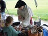 Teaching visitors how to make feather darts