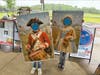 Two young visitors having pictures taken as a drummer boy and colonial girl