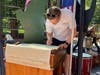A visitor signing the copy of the Declaration of Independence